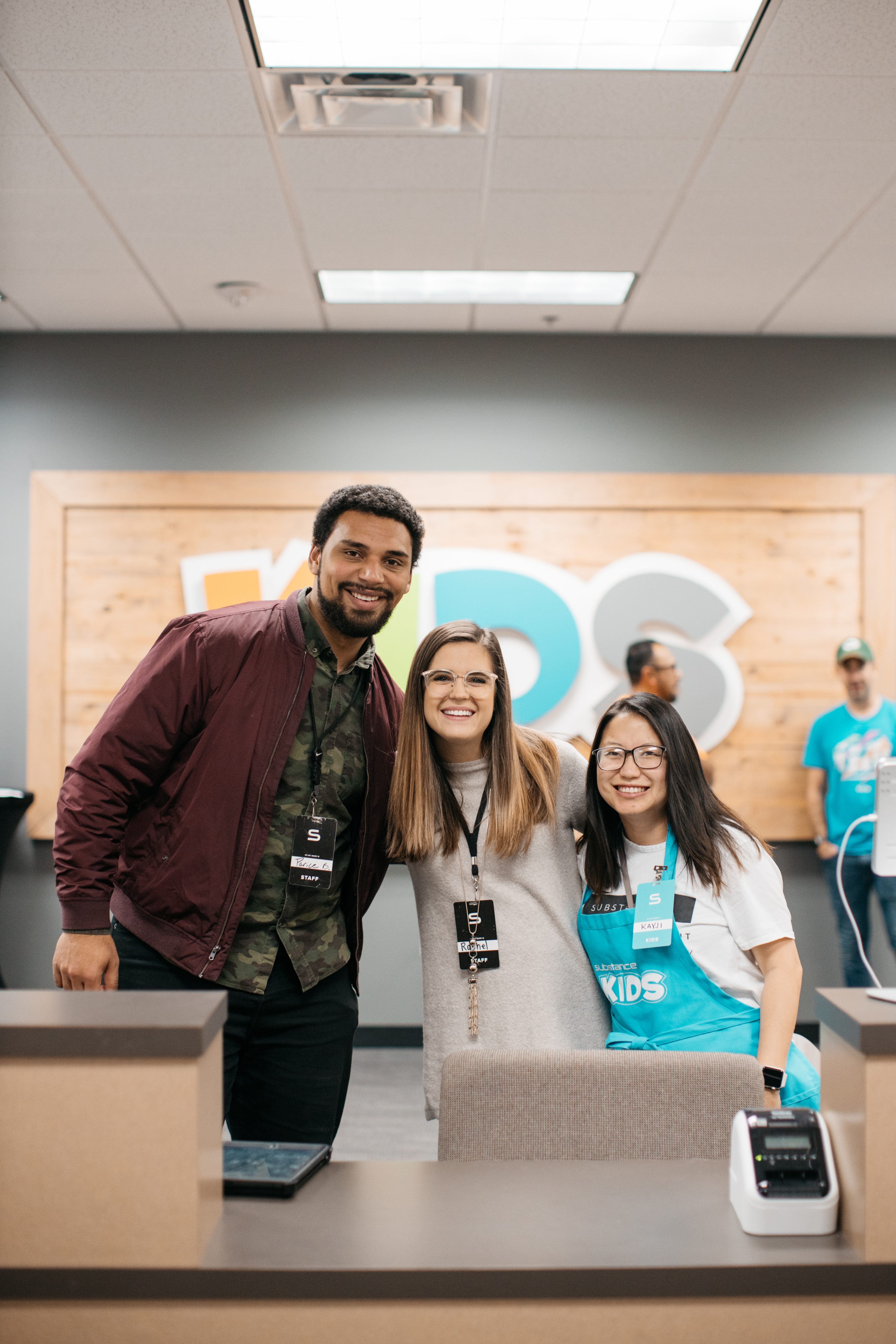Substance Kids volunteers smiling at the check-in desk